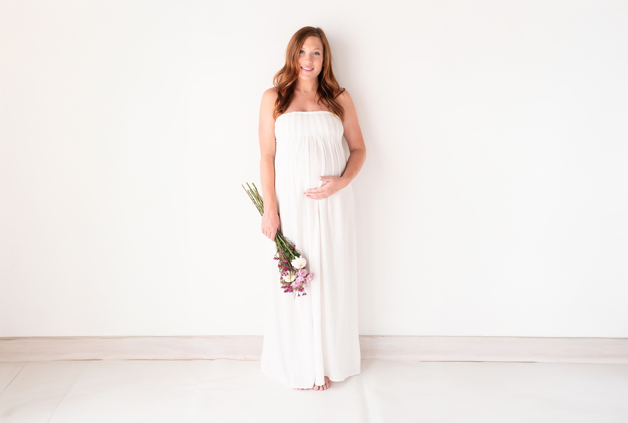 Woman in White Dress holding flowers - Heather Parrish Photography